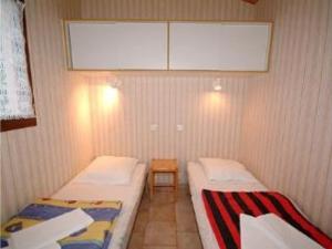 a small room with two beds and a window at Maison avec animaux admis - 4 pers. - API-1-52-2864 in Saint-Rome-de-Tarn +20 photos
