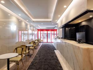 a bar with tables and chairs in a restaurant at Hotel Neo Rouge in Tokyo