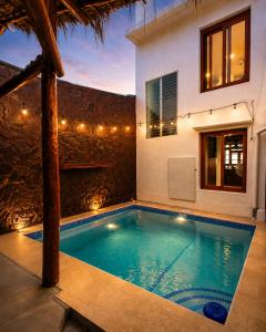 a swimming pool in the backyard of a house at Hotel Ocean View in San Juan del Sur