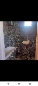 a bathroom with a bath tub and a sink at Duplex con cochera in Paraná