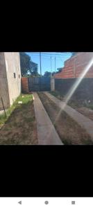a view of a street with a fence and a sidewalk at Duplex con cochera in Paraná