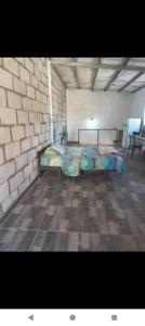 a bedroom with a bed in a brick wall at Duplex con cochera in Paraná