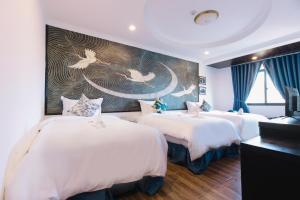 a hotel room with three beds with birds on the wall at Orchid Hotel in Hue +39 photos