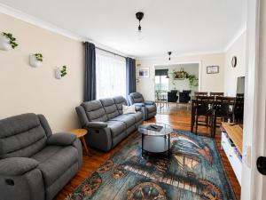 a living room with couches and a dining room at Smugglers Cove in Esperance
