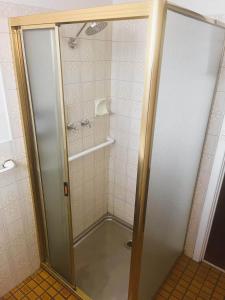 a shower with a glass door in a bathroom at Smugglers Cove in Esperance +12 photos