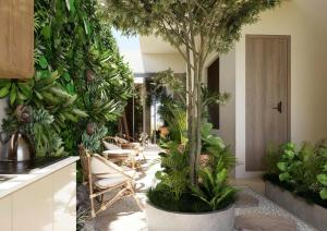 a room with plants and a table and chairs at Tổ Homestay in Thôn Kim Long (1)