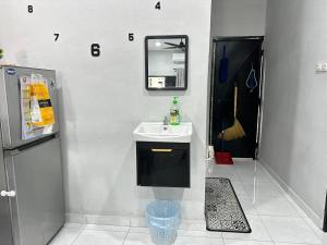 a bathroom with a sink and a mirror at Aden's Stopover House in Kuala Nerang +13 photos