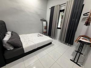 a small bedroom with a bed and a mirror at Aden's Stopover House in Kuala Nerang