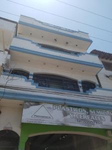 a tall building with a sign in front of it at hostal la playa vallarta in Puerto Vallarta