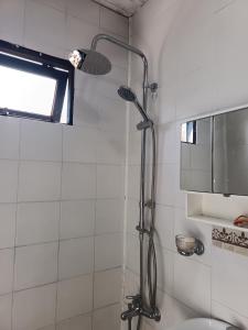 a shower in a bathroom with a shower head at Cabaña Terra Nostra in Potrerillos