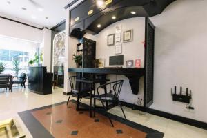 a home office with a desk and chairs at Orchid Hotel in Hue