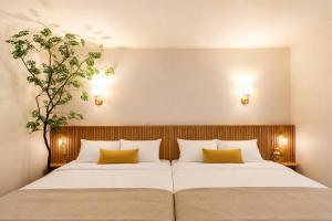 a bedroom with two beds and a tree on the wall at 잠실 트리하우스 KSPO돔 인근 Lotte World in Seoul