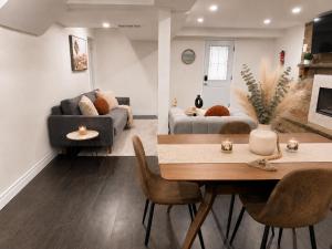 a living room with a table and a couch at Chic & Spacious 2BR Home Near Yonge St in Newmarket