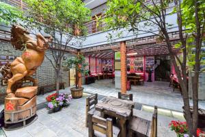 a statue of a horse and a table in front of a building at Dali Classical Rosewood Boutique Inn in Dali +11 photos
