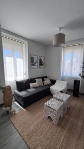 a living room with a couch and a table at Zen Terrace Townhouse in Faro