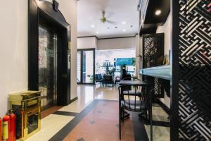 a restaurant lobby with a bar and chairs at Orchid Hotel in Hue