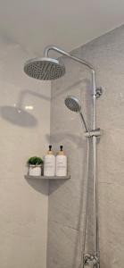 a shower with two soap bottles on a shelf at Nala Host - Maafushi Homes in Maafushi +80 photos