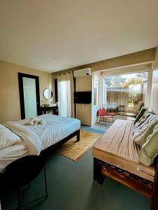a bedroom with a large bed and a large window at The Ronin in General Luna