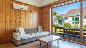 a living room with a couch and a table at Daebu-do, White Island Pension in Ansan