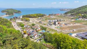 an aerial view of a town next to a body of water at Daebu-do, White Island Pension in Ansan