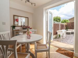 a kitchen and dining room with a table and chairs at Bluebell Cottage in Selby