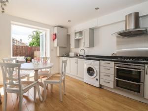 a kitchen with a table and a table and chairs at Bluebell Cottage in Selby +16 photos