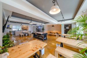 a large room with tables and a pool table at Visitor guesthouse in Jeju