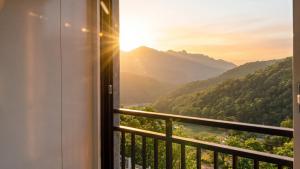 a room with a balcony with a view of the mountains at Sara&Forest Pension Mungyeong in Mungyeong +2 photos