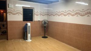 a room with a room with a fan and a window at Samarpit Guest House in Devgarh