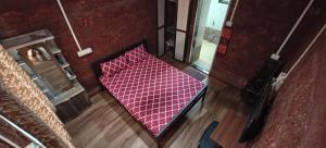 an overhead view of a red bed in a room at Samarpit Guest House in Devgarh