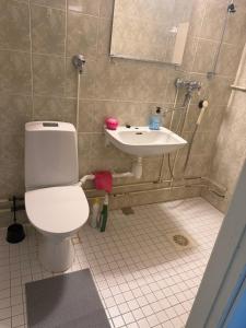 a bathroom with a toilet and a sink at Style studio in Lohja in Lohja