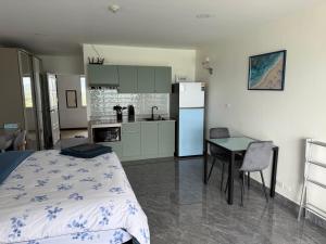 a bedroom with a bed and a table and a kitchen at New world condo1802 in Rayong