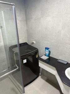 a bathroom with a shower and a sink at New world condo1802 in Rayong +14 photos