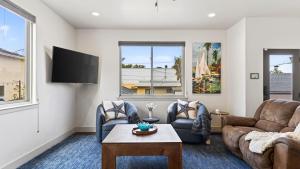 a living room with two couches and a tv at Stimson Coastal Luxury by AvantStay in Pismo Beach