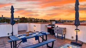 a kitchen with a table and a stove on a roof at Stimson Coastal Luxury by AvantStay in Pismo Beach