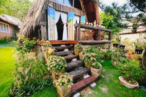 a house with a staircase leading up to a house at Veranda Resort Phan Thiết in Tiến Thành