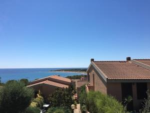 ヴィッラプッツにあるCasa Vacanza Porto Coralloの海を背景にした家の風景