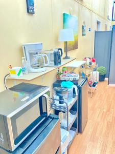 a room with a kitchen with a counter with a microwave at Near Yellowstone Park and Chico Hot Springs in Emigrant