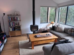 a living room with a couch and a wood stove at The Perch in Nornalup