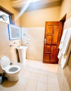 a bathroom with a toilet and a sink at Escape Retreat Hunza in Karimabad Hunza +44 photos