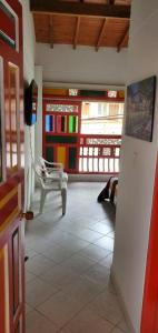 a room with a chair and a room with windows at Refugio Sereno en Jericó 1 in Jericó