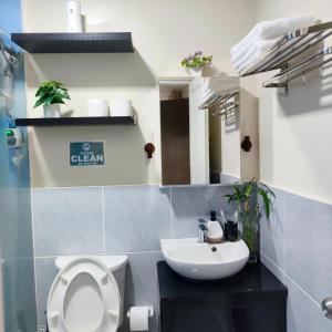 a bathroom with a white toilet and a sink at Villa Bosque - Forest Residences in Antipolo +17 photos