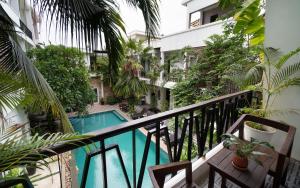 a balcony with a swimming pool in a building at Boutique Indochine d'Angkor in Siem Reap +92 photos