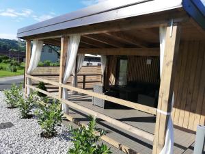 a wooden pergola with awning on a deck at Apartma Dečko Rogaška in Rogaška Slatina