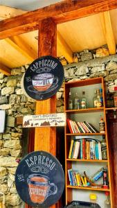 two signs on the wall of a coffee shop at Escape Retreat Hunza in Karimabad Hunza