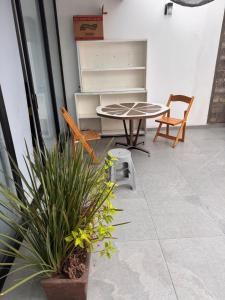 a patio with a table and chairs and plants at Havana House in Mexico City
