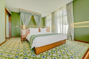a bedroom with a large bed in a green room at Shigatse Summer Palace Healing Hotel in Shigatse