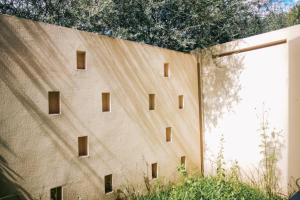 a building with small windows on the side of it at Shigatse Summer Palace Healing Hotel in Shigatse +51 photos