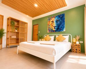 a bedroom with a bed with a painting of a lion at Oh’lala - 3 BR Pool Villa in Ban Tai