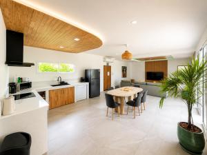 a kitchen and living room with a table and chairs at Oh’lala - 3 BR Pool Villa in Ban Tai